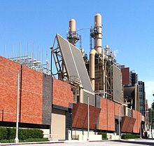 an industrial building with many pipes and cooling towers on the top of it's roof