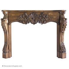 an ornate gold fireplace mantel with carvings on the top and sides, along with a white background