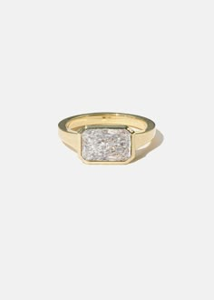 a gold ring with a square shaped diamond in the center