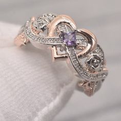 A crystal ring meant for anyone looking for some uplifting energy and support, the Amethyst Square Crystal Ring is a beautiful stone surrounded by supportive white Topaz and one mesmerizing purple Amethyst. This means you will be receiving an abundance of healing power from not only the stones but also from this delicately crafted piece that looks gorgeous adorning any finger. ﻿Amethyst benefits: In addition to revealing one’s destiny, traits and powers, wearing Amethyst also keeps the wearer pr Purple Rings Engagement, Purple Wedding Rings, Amethyst Benefits, Amethyst Wedding Rings, Purple Ring, Square Crystal, Purple Rings, Infinity Love, Infinity Heart