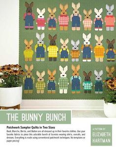 the bunny bunch quilt pattern is displayed on a table next to potted plants and flowers