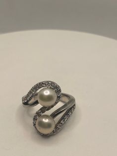 Vintage pearl cocktail ring Lovely 925 sterling silver set with white Pearl set in very detailed vintage filigree tarnished from age. Size 8 My jeweler can re size for a $10-$20 fee All rings are shipped free in the US in a nice gift box. Check out our over a THOUSAND great reviews!!! Engraving is $4 per letter and is not always perfect depending on the piece. It can take a few days if the jeweler is busy. This is payable to Paypal Judithsltd@gmail.com Luxury Brilliant Cut Pearl Ring In Sterling Silver, Elegant 925 Stamped Pearl Promise Ring, Elegant Sterling Silver Pearl Ring Stamped 925, Elegant Silver Pearl Ring Stamped 925, Wedding Pearl Ring Stamped 925 In Sterling Silver, Wedding Pearl Ring In Sterling Silver, Silver Pearl Drop Jewelry For Anniversary, Stamped 925 Pearl Ring For Wedding, Classic Diamond White Pearl Ring Gift