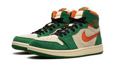 The Air Jordan 1 High Zoom CMFT 2 "Pine Green" is a colorway of the modified version of the retro basketball shoe with green and orange details.  The Jordan 1 Zoom Comfort 2 is the second version of the Jordan 1 Zoom Comfort shoe that puts a casual, more comofrtable spin on the classic silhouette.  The “Pine Green” features a Muslin suede base with Pine Green suede overlays.  An Orange Blaze cut-out Swoosh appears on the sides and a “Wings” logo is found on the collar.  “Zoom Air” branding repla Pine Green Outfit, High Top Nikes, Orange Nike Shoes, Air Jordan 1 Zoom Cmft, Green Jordans, Jordan New, Shoes Streetwear, Orange Details, Retro Basketball Shoes