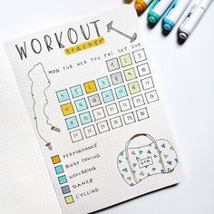 a notebook with the words workout written on it next to crayons and markers