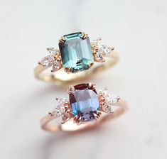 two rings with different colored stones on them