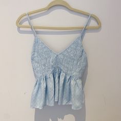 Condition: Never Before Worn, Original Tags Intact Style: Sleeveless Pastel Blue Tank Top, V-Neck, Ruffle Accents, Ruched Bust, Embroidered Design Brand: Cotton Candy La Fabric: 100% Rayon Size: Us Medium, Fits True To Size, Flexible To Various Bust Sizes Due To Elasticity Completly Sold Out Online V-neck Ruffled Camisole For Vacation, Blue Cotton Tank Top With Ruffles, Spring V-neck Tank Top With Ruffles, Casual Blue Ruffled Tank Top, Light Blue Sleeveless Camisole, Spring V-neck Ruffled Tank Top, V-neck Ruffled Tank Top For Spring, Light Blue V-neck Camisole For Spring, Blue Ruffled Cami Tank Top