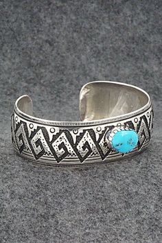 This beautiful turquoise and sterling silver bracelet was made by Navajo silversmith Richard Singer. The back is signed R Singer and stamped .925.Size: 6 7/8" (will fit up to a 8" wrist)Gap: 1 1/8"Width: 1"Free shipping on all orders! We ship with USPS and always include tracking. All orders ship within a day of payment.Returns are accepted up to 30 days after you receive your order. Just send us a message. Our shop offers cash back or store credit. The item must be returned in new condition. Stamped Turquoise Sterling Silver Bracelet, Stamped Sterling Silver Bracelet In Turquoise, Sterling Silver Turquoise Stamped Bracelet, Bohemian Engraved Turquoise Sterling Silver Bracelet, Bohemian Turquoise Engraved Sterling Silver Bracelet, Southwestern Etched Turquoise Jewelry, Southwestern Turquoise Etched Jewelry, Southwestern Style Etched Turquoise Jewelry, Traditional Turquoise Sterling Silver Cuff Bracelet