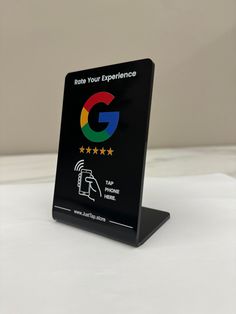 a black plaque with the google logo and five stars on it that says, now your experience