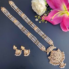 Featuring a 22k gold jadau rani haar set in all pearls. The necklace weighs 73.35 gms including 2.30 gms in the hanging beads and 23.25 gms in the 4 lines of pearls strings. The earrings weigh 10.75 gms including 1.15 gms in the hanging pearl beads Diwali White Kundan Necklace In 22k Gold, White 22k Gold Kundan Necklace For Diwali, 22k Gold Pearl Necklace For Diwali, Gold Chandbali Pearl Necklace For Puja, White 22k Gold Kundan Necklace With Intricate Design, White 22k Gold Kundan Necklace For Festivals, Diwali 22k Gold Temple Jewelry Pearl Necklace, White 22k Gold Temple Jewelry Bridal Necklace, Festive White 22k Gold Bridal Necklace