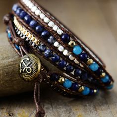 Introducing the Ethnic Blue Chic Wrap Bracelet, a stunning accessory that brings beauty and harmony to your daily life. Crafted with high-quality gemstones, this bracelet exudes a sense of elegance and sophistication, making it a perfect complement to any outfit. Not only does it enhance your appearance, but it also promotes balance and positive energy flow throughout your body. *Material: Jasper, Lapis Lazuli, Jade, Wax rope, Metal *Making Technics: Handmade Sewed *Size: 32.5 inches, 3 closures Elegant Turquoise Bracelets, Elegant Crystal Gemstone Bracelet For Meditation, Adjustable Lapis Lazuli Beaded Bracelets Bohemian Style, Blue Spiritual Wrap Bracelet With Gemstone Beads, Spiritual Blue Gemstone Beads Wrap Bracelet, Spiritual Blue Wrap Bracelet With Gemstone Beads, Elegant Beaded Wrap Bracelet As Gift, Blue Gemstone Beads Wrap Bracelet With Round Beads, Blue Bracelets With Round Beads For Fashion