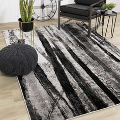 a black and white area rug in a living room with chairs, plant and clock on the wall