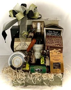 a wine and cheese gift basket is shown in this image, it's perfect for someone who wants something special to eat