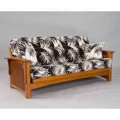 a wooden couch with black and white fabric on it