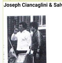 two men standing next to each other in front of a building with the caption joseph ciancacchini & salvini