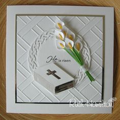 a card with flowers and a cross on it