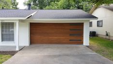 a white house with a brown garage door