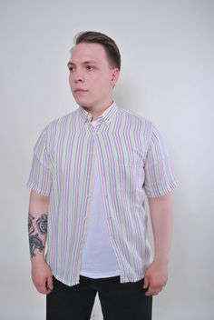 "Vintage men multicolor summer short sleeve striped shirt, Size S Welcome to TARASCOMMON.ETSY.COM Unique clothing from the 20th century. Model tall - 175cm S. Sleeve - 12cm / 4.72inch; ( armpit to end of sleeve); Width - 53cm / 20.86inch; Length - 75cm / 29.52inch. All measurements are taken seam to seam while lying flat. Cotton/polyester. France. This item is vintage, so it can have some defects. Additional photos can be send We are glad that you are interested in lots that we sell. Wish you a White Summer Shirt With Striped Collar, Spring Vertical Stripes Short Sleeve Shirt, Multicolor Horizontal Stripe Summer Tops, Beach Tops With Striped Collar And Short Sleeves, White Short Sleeve Shirt With Horizontal Stripes, Striped Short Sleeve Beach Shirt, White Yarn-dyed Short Sleeve Shirt, Striped Short Sleeve Shirt For Spring, Striped Short Sleeve Yarn-dyed Top