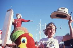 a young boy is holding up a stuffed animal and another toy in front of him