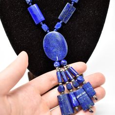 DETAILS * Set with Lapis Lazuli stones from Afghanistan * Necklace Length: 50 cm // 19.7 inches * Middle Stone Dimensions : 35 x 27 mm // 1.37 x 1.06 inches LAPIS LAZULI QUALITY FACTORS  In its most-prized form, lapis lazuli has no visible white calcite, although it might contain gold-colored pyrite flecks. If the flecks are small and sprinkled attractively throughout the gem, their presence don't lower the value of the stone.  Afghan lapis is known internationally for its intense, saturated and uniform royal blue color. It contains little or no pyrite, and no calcite. Thus, it is the highest and most expensive grade of lapis found on the market.  Source: Gemological Institute of America (GIA) ENVIRONMENTAL SUSTAINABILITY Every business has an environmental and ethical impact: a small jewe White Calcite, Jewelry Big, Blue Antique, Lapis Lazuli Pendant, Lapis Lazuli Necklace, Muslin Bags, Lapis Blue, Lapis Lazuli Stone, Royal Blue Color