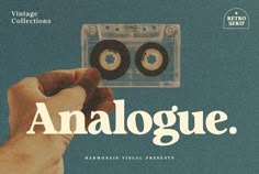 a hand holding an old fashioned cassette with the word analogue written below it in white on a blue background