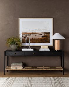 a black console table with a white lamp on top and a brown wall behind it