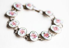 Sterling Silver Pink Enamel Flower Bracelet Handmade Oval Sterling Silver Bracelet In Vintage Style, Silver Enamel Bracelets For Wedding, Vintage White Flower Bracelets, Silver Vintage Flower Bracelet, Pink Sterling Silver Flower-shaped Jewelry, Silver Flower Enamel Earrings, Vintage Silver Flower Bracelets, Vintage Round Enamel Bracelets, Vintage Oval Enamel Jewelry