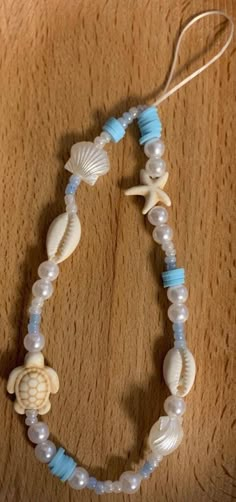 This is a ocean themed hand made phone charms, made by me ! :) Phone Charm With Clay Beads, Beads Phone Charm Ideas, Bracelets Ideas For Summer, Cute Clay Bead Phone Charm Ideas, Summer Vibes Bracelets, Aesthetic Clay Beads Ideas, Clay Bead Phone Charm Ideas Summer, Cool Bracelets With Beads, Beach Themed Beaded Bracelets