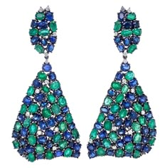 18K Black Rhodium Gold. Emeralds: 17.42ct total weight. Blue Sapphires: 22.30ct total weight. Diamonds: 1.04ct total weight. All diamonds are G-H/SI stones. Emerald Drop Earrings, Diamond Chandelier Earrings, Diamond Chandelier, Peacock Colors, Emerald Blue, Blue Sapphire Diamond, Expensive Jewelry, Emerald Earrings, Women Diamond