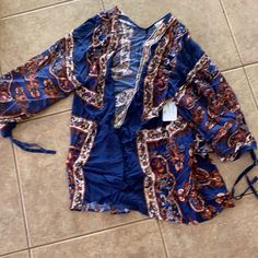 Size Medium/Large Orange Long Sleeve Top For Beach Season, Long Sleeve Orange Tops For Beach Season, Blue Boho Print Top For Fall, Blue Boho Print Tops For Fall, Blue Long Sleeve Blouse With Vibrant Print, Blue Tops For Beach Season Brunch, Casual Blue Blouse For Beach Season, Blue Tops For Brunch During Beach Season, Long Sleeve Summer Blouse In Blue