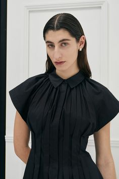 The signature Unchartered shirt dress in Cotton returns, in the much anticipated Black colour this season. Find out why so many have fallen in love with this style, with its uniquely tapered box pleats at the waist, giving the dress a flattering silhouette. The style also features open shaped sleeves and a concealed button front opening and side pockets for ease of wear. Colour: Black Also available in Ivory and Lilac colour-ways. Fit: Regular fit overall, slim fitting at waist.Model is wearing Black Dress Style, Bauhaus Architecture, Lilac Colour, Garment Care Labels, Colour Ways, Pleated Shirt, Online Fashion Boutique, Lilac Color, Casual Office