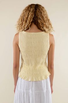 Introducing our Glo Smocked Tank in a light yellow hue. With its smocked texture and boat neck style, it's the perfect elevated basic for spring and summer. Material & Care: Crafted from 97% Rayon and 3% Spandex. Hand wash in cold water with mild detergent. Lay flat to dry. Avoid bleach and dry cleaning. Size & Fit: Model is wearing a size small Yellow Fitted Smocked Top, Fitted Yellow Smocked Top, Yellow Smocked Bodice Top For Summer, Summer Smocked Ruched Top, Summer Tops With Smocked Bodice In Solid Color, Summer Tops With Smocked Bodice, Spring Smocked Back Top In Solid Color, Spring Solid Color Smocked Back Top, Yellow Ruched Tops For Spring