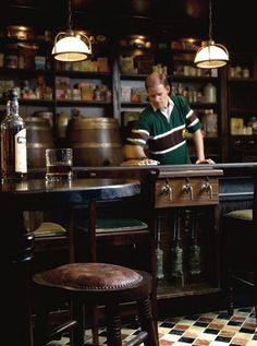 a man standing behind a bar in a restaurant