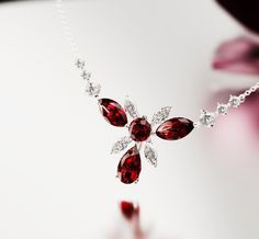 Introducing Crimson Bloom: Crafted as a romantic high-end floral necklace to complement any of our other pieces as a set or to shine brightly on it's own. This classical necklace is perfect for any occassion. As a gift for her, a supplement to an engagement ring or a gift for yourself - because you deserve it - it is guaranteed to impress. A bright and shiny string of simulated diamonds and garnets make this necklace stand out and is sure to bring lots of compliments. Each stone shines brightly Necklace Stand, Garnet Necklace, Ruby Necklace, You Deserve It, Floral Necklace, Red Stone, To Shine, Free Jewelry, Send Me