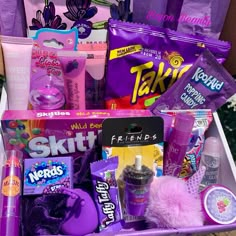 a purple basket filled with lots of different types of candy and other things to put in it