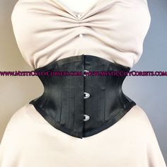 "New UNDERBUST from \"MystiC City Corsets\" design: MCC152 ORIGINAL design/photo: \"MystiC City Corsets\" - fashion layer: black cotton/black satin - lining: 100% cotton twill steel boning - 6 x 12mm wide \"white\" flat steel flexible bones - 10 x 6mm wide spiral steel bones ( sizes: 16, 18\" has 10 spiral bones) - steel busk - floating modesty panel: 5\" wide ( boned) - waist tape - high quality 1/4\" grommets waist can stretch a bit and sizes runs big for ex: size 22\" is more close to 23\""