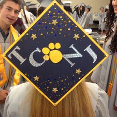 a graduate's cap with the word rock on it and a dog paw in the center