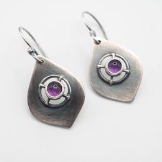 Sterling silver dangle earrings featuring a genuine 5mm Amethyst stone with a drop length of 40mm (1.57"). Perfect for everyday wear with any outfit, combining boho and chic styles. All of our pieces are made to order, so please allow for roughly 1-3 days for us to create your unique item. While we strive to make our products match the photos as closely as possible, please keep in mind that there may be slight variations. If you want to see more of our handmade earrings, please visit our Etsy sh Handmade Purple Sterling Silver Earrings, Modern Purple Dangle Jewelry, Modern Purple Gemstone Earrings, Purple Sterling Silver Teardrop Dangle Earrings, Purple Modern Sterling Silver Earrings, Purple Teardrop Metal Earrings, Modern Purple Sterling Silver Earrings, Modern Amethyst Gemstone Earrings, Modern Amethyst Earrings As Gift