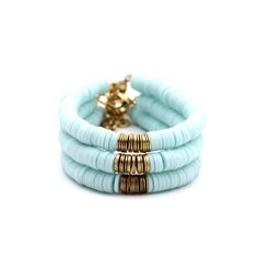 A light blue heishi bead bracelet is the perfect on-trend accessory to top off your look. It is a great stand alone bracelet and works well as a stack bracelet, too. This non-stretch bracelet features light blue polymer clay heishi beads with gold brushed metal beads in the center, all hand-strung onto flexible jewelry wire. The bracelet is finished off with a lobster clasp, and a 1" extender chain to accommodate various wrist sizes. MATERIALS Polymer Clay & Metal Beads SIZE 6 1/2" Extendable Up Blue Heishi Bracelet Ideas, Swiftie Bracelets, Light Blue Purse, Light Blue Bracelet, Heishi Jewelry, Heishi Bead Bracelet, Blue Polymer Clay, Clay Bracelets, Stack Bracelet