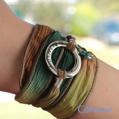 a woman's arm with several bracelets on it