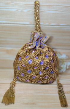 Indian Golden purple Color Women Fashion Handmade Potli Bag, Ethnic Wedding hand bag, Bridal Bag Embellished With Beads & Sequins Potli Bag  Dimensions: Length: 8.5 inches Width: 7.0 inches Depth: 8.0 inches This Handmade Beaded potli bag is good match for beautiful Women with both Indian wedding and Festivals.  The bag is embellished with high quality semi-precious stones like pearls, beads, crystals, sequins on a beautiful high quality fabrics. Two drawstrings at both ends give our Potly bag a stunning look. Wrist handle studded with beads.  This Hand Pouch would be best complement to your designer saree, lehanga or any other kind of Western Wear dress. The ideal gifts for your daughters, mothers, grandmothers, colleagues, partners, students, and girlfriends. Each of our products is havi Western Wear Dresses, Potli Bag, Ethnic Wedding, Wedding Hands, Bridal Bag, Potli Bags, Designer Saree, Beaded Bags, Lining Fabric