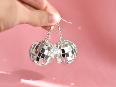 Some fun disco ball earrings, sure to be a showstopper! Super fun for bachelorette parties, music festivals, and roller rinks too. Thanks for takin' a look, if you have any questions just lemme know! If you plan on ordering more than 10 message me and I'll give you a discount code :) 🌼Earring: Silver Hook  🌼Charm: Disco Ball 🌼Size: Full length measures 2 inches  🌼 Color: Silver 🌼These earrings a premade and ready to ship immediately :) If you have a custom request, lemme know! I'd love to w Ball Party Aesthetic, 70s Disco Outfit, 70s Birthday, Disco Ball Party, Ears Tour, Beyonce Concert, Disco Ball Earrings, 70s Earrings, Disco Party Decorations