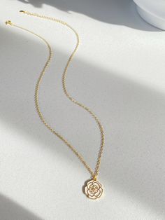 Adorn yourself with the beauty of nature with our Camellia pendant necklace! This necklace features a stunning camellia flower that represents love, admiration and gratitude. The elegant design is completed with sterling silver plated with gold cable chain, making it perfect for everyday wear or special occasions.  It's so beautiful either have it alone or layered with other necklace, have it with dress or sweater. Pendant size is 1.2cm Necklace length is 40+5.5cm As it's a handmade item please allow 2-3mm difference. Please keep them away from chemicals such as perfume, hairspray ect. Better remove before shower and swim.   The product is made by care and love 💕 Elegant Rose Flower Pendant Charm Necklaces, Elegant Rose Gold Flower Charm Necklaces, Elegant Rose Gold Flower Charm Necklace, Elegant Rose Design Charm Necklace For Gift, Elegant Rose Design Charm Necklace Gift, Elegant Rose Necklaces With Clavicle Chain, Elegant Rose Necklace For Her, Elegant Rose Design Necklace For Mother's Day, Elegant Flower Charm Necklace With Clavicle Chain