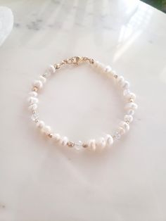 * This dainty bracelet is perfect for a wedding or layered with bangles! Dress it up or down. * Genuine freshwater pearls are arranged thoughtfully among 14k gold filled beads, and faceted rainbow moonstone. No one of these bracelets will be exactly the same, making each one unique 💫 * Secure with all 14k gold filled findings and easy to use lobster clasp. * Made from top quality materials, gold fill won't tarnish or turn, wear 24/7. **Pro tip** For measuring your wrist- If you don't have a fle Dainty Moonstone Beaded Bracelet Adjustable, Dainty Hand-strung Pearl Bracelets, Dainty Gold-plated Pearl Bracelet With Adjustable Chain, Dainty Pearl Bracelet, Adjustable 14k Gold-filled Pearl Bracelet, Adjustable 14k Gold-filled Pearl Bracelet For Wedding, Gold Bead Bracelet, Bridal Bracelet Pearl, Bracelet Pearl