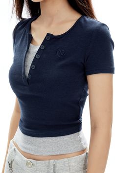 Revamp your everyday look with the allure of the Ribbed Henley Mock Two-Piece Short Sleeve Crop Top. 

This piece is a seamless fusion of sophistication and understated *style, crafted from a quality blend of 48% cotton and 52% synthetic fibers, including a touch of spandex for that flawless fitted silhouette. The V-neckline and ribbed texture add a classic touch, while the mock two-piece design offers a trendy, layered appearance without the bulk. 

Elevate your casual repertoire by pairing it Henley Tank Top Outfit, Henley Top Outfit, Crop Top Layering, Grunge Accessories, Chic Lounge, Simple Wardrobe, Understated Style, Tank Top Outfits, Short Sleeve Crop Top