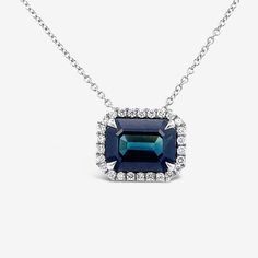 This stunning necklace combines Blue Sapphire and Diamonds for a look that radiates luxury. The 4.20ct Emerald Cut Sapphire is top top gem quality, surrounded by a halo of White Diamonds. Add a touch of timeless elegance to your jewelry collection. Blue Sapphire 4.20ct Natural Round Diamonds 0.28cttw 18K White Gold Length: 18"Inches Luxury Sapphire Necklace With Halo Setting, East West Setting, Sapphire Diamond Necklace, Bracelet And Ring, Matching Bracelet, Top Top, Natural Blue Sapphire, Stunning Necklace, East West