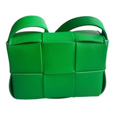 Experience the luxurious craftsmanship of the Bottega Veneta Candy Cassette Mini Bag in Green. Made from premium woven grained lambskin, this messenger bag offers a vibrant and eye-catching color. With an adjustable shoulder strap and a card slot pocket, it's the perfect combination of practicality and style. The fold-over flap and magnetic closure ensure the safety of your belongings. Measuring H3.5 x W5 x D2 inches, this bag is the epitome of designer excellence with its iconic Intrecciato wea New Bottega, Bag Green, Eye Catching Colors, Green Bag, Mens Shirt Dress, Magnetic Closure, Cloth Bags, Salvatore Ferragamo, Emporio Armani