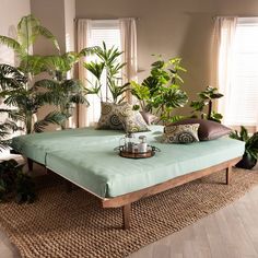 a bed with pillows and plants on top of it