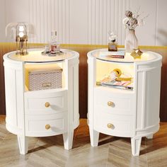 two white night stands with drawers on each side