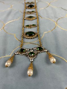 Wow! This exquisite antique belt made of rhinestones, green stones and glass pearls comes from a German collection of theatrical jewelry. Very artistically crafted. And older than you might think. It probably dates from the period between 1890-1910. Actresses wore it on stage in exotic roles (like Salome).  In very good to excellent condition. Original condition. Nothing altered.  Very, very rare to find. Even rarer are these pieces offered for sale. Most are in private collections. Traditional Embellished Wedding Necklaces, Victorian Jeweled Evening Jewelry, Ornate Jeweled Jewelry For Evening, Antique Green Jewelry For Evening, Traditional Embellished Formal Jewelry, Traditional Embellished Necklaces For Parties, Ceremonial Green Beaded Jewelry, Traditional Embellished Party Necklace, Green Beaded Jewelry For Ceremonial Occasions