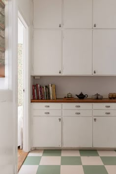 a kitchen with green and white checkered flooring